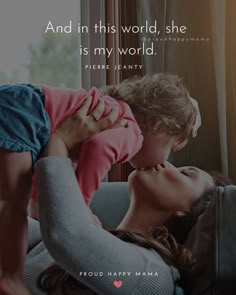 a mother kissing her child on the cheek with a quote above it that says, and in this world she is my world