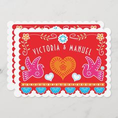 a red and orange wedding card with two birds in the middle, on a marble surface