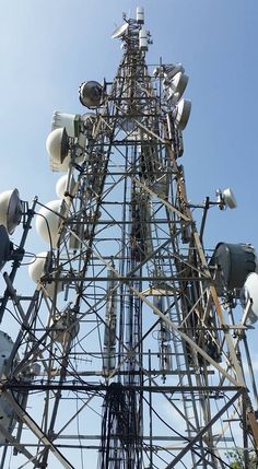 the tower has many different types of electrical equipment on it's top and sides