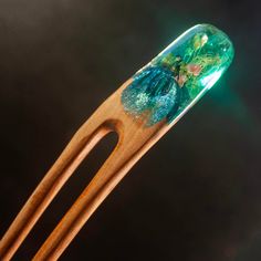 Handmade with care and inspired by the stunning Irish nature, this hair fork is a true work of art. Made of high-quality wood and blue tones resin. It features lichen and flowers. Each hair fork is polished to a clear high gloss finish and the wood is sealed with Danish oil, giving it a smooth and luxurious feel.  *GIFT BOX INCLUDED* DIMENSIONS approx: - High - 165 mm - Resin top width - 25 mm SHIPPING All orders are dispatched using registered shipping with tracking number. Irish Nature, Hair Accessories Bun, Resin Top, Wild Garden, Hair Fork, Danish Oil, Hair Stick, Hair Sticks, Blue Tones