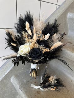 a bridal bouquet with feathers and flowers