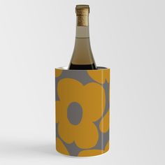 a bottle of wine in a yellow and gray cup