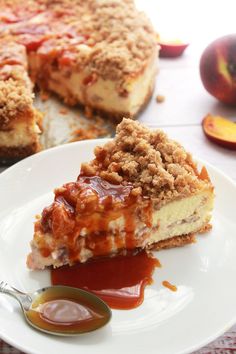 a slice of cheesecake on a plate with caramel sauce and an apple in the background