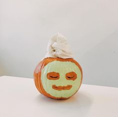 a pumpkin with a face painted on it