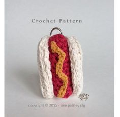 a crocheted hot dog with mustard and ketchup