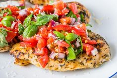 grilled chicken with tomatoes and basil on top