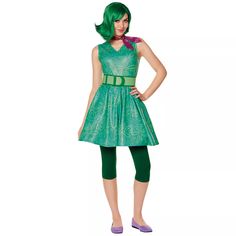 a woman in a green dress is standing with her hands on her hips