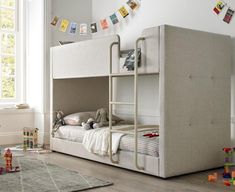 a child's bedroom with a bunk bed and toys on the floor in front of it