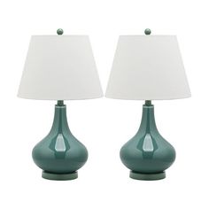 two green vases with white lamps on them