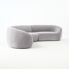 a gray couch sitting on top of a white floor