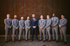 a group of men in suits standing next to each other