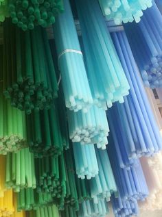 many different colored straws stacked on top of each other