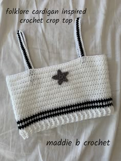 a crocheted bag with a star on the front and black stripes around it