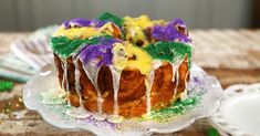 a bundt cake covered in icing and colored sprinkles on a plate