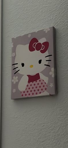 a hello kitty painting hanging on the wall