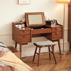 a bedroom with a vanity and stool in it