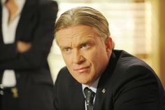 a man in a suit and tie sitting at a table