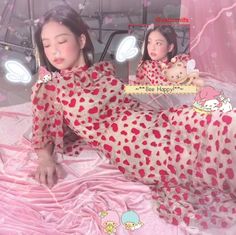 a woman laying on top of a bed holding a teddy bear