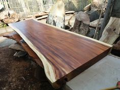 a large wooden slab sitting on top of a pile of wood