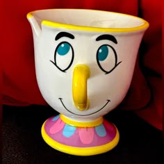 a close up of a cup with a face on it