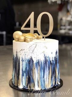 a white and blue cake with the number forty on it