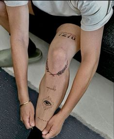 a person with tattoos on their legs and knee