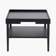 a black coffee table with two shelves on each side and an open drawer underneath it