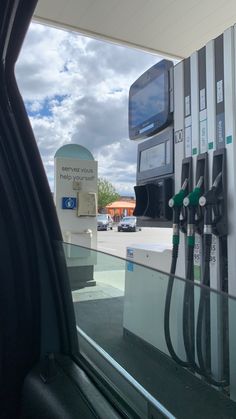 an electric car charging at a gas station