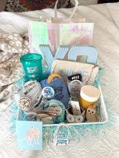 a basket filled with lots of items on top of a bed