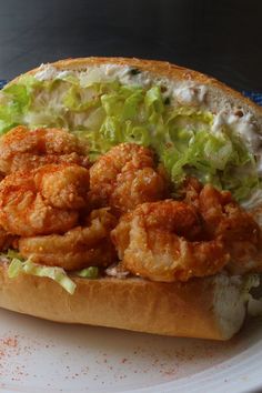 there is a sandwich with shrimp and lettuce on it