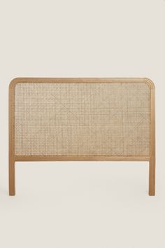 the headboard is made out of wood and has a woven design on it's sides