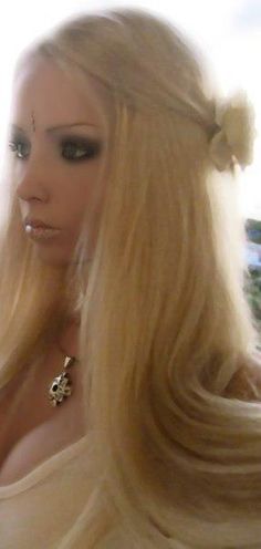 a woman with long blonde hair wearing a bow in her hair