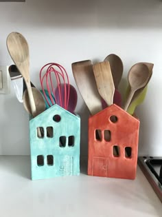 three wooden spoons and two ceramic houses