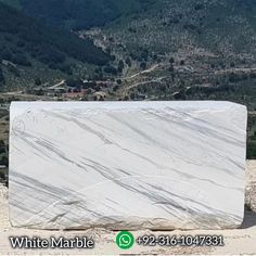 a large white marble slab sitting on top of a mountain