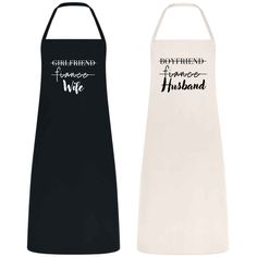 two black and white aprons, one with the words