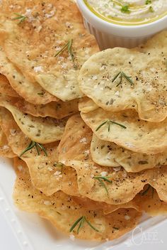 a white plate topped with crackers and dip