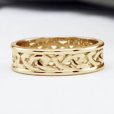 a gold ring with an intricate design on it