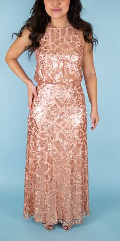 td {border: 1px solid #ccc;}br {mso-data-placement:same-cell;} Beautiful sequined gown featuring a halter neck. Perfect for a maid of honor or some sparkle in your bridal party. Brand: Donna Morgan Retail Price: $290 Color: Rose Gold Interior: Nylon; Exterior: Polyester Fully Lined Model Info: Height: 5'2 Waist: 26'' Wearing a size 2 *Style Notes: This dress runs small.