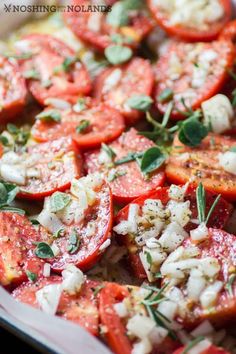 tomatoes and feta cheese with herbs on top