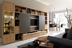 a living room with a large entertainment center in it's centerpiece and shelves