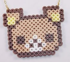 a necklace made out of beads with a cat on it