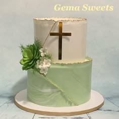 a green and white cake with a cross on the top that says gena sweets