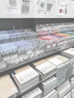 the shelves are filled with many different colored pens