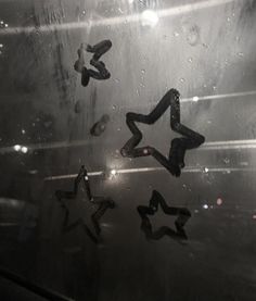 the stars are reflected in the water on the window sill, with raindrops all around them