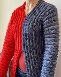 a mannequin wearing a red and blue cardigan next to a gray knitted sweater