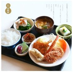 there is a tray with different types of food on it, including rice and meats