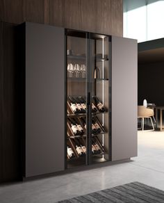 a wine cabinet with many bottles and glasses in it