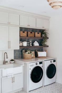 a washer and dryer in a white laundry room