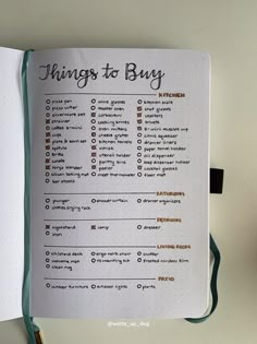 an open notebook with the words things to buy on it