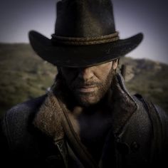 a man wearing a hat and jacket in the desert